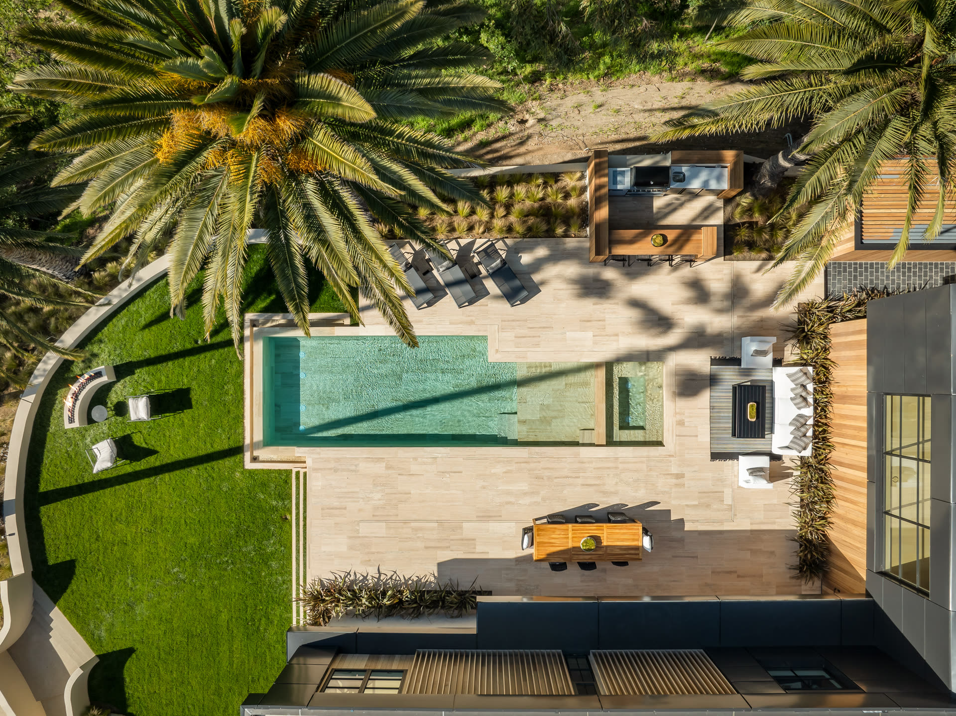 Aerial view of 879 Linda Flora with pool, travertine terrace, and palms
