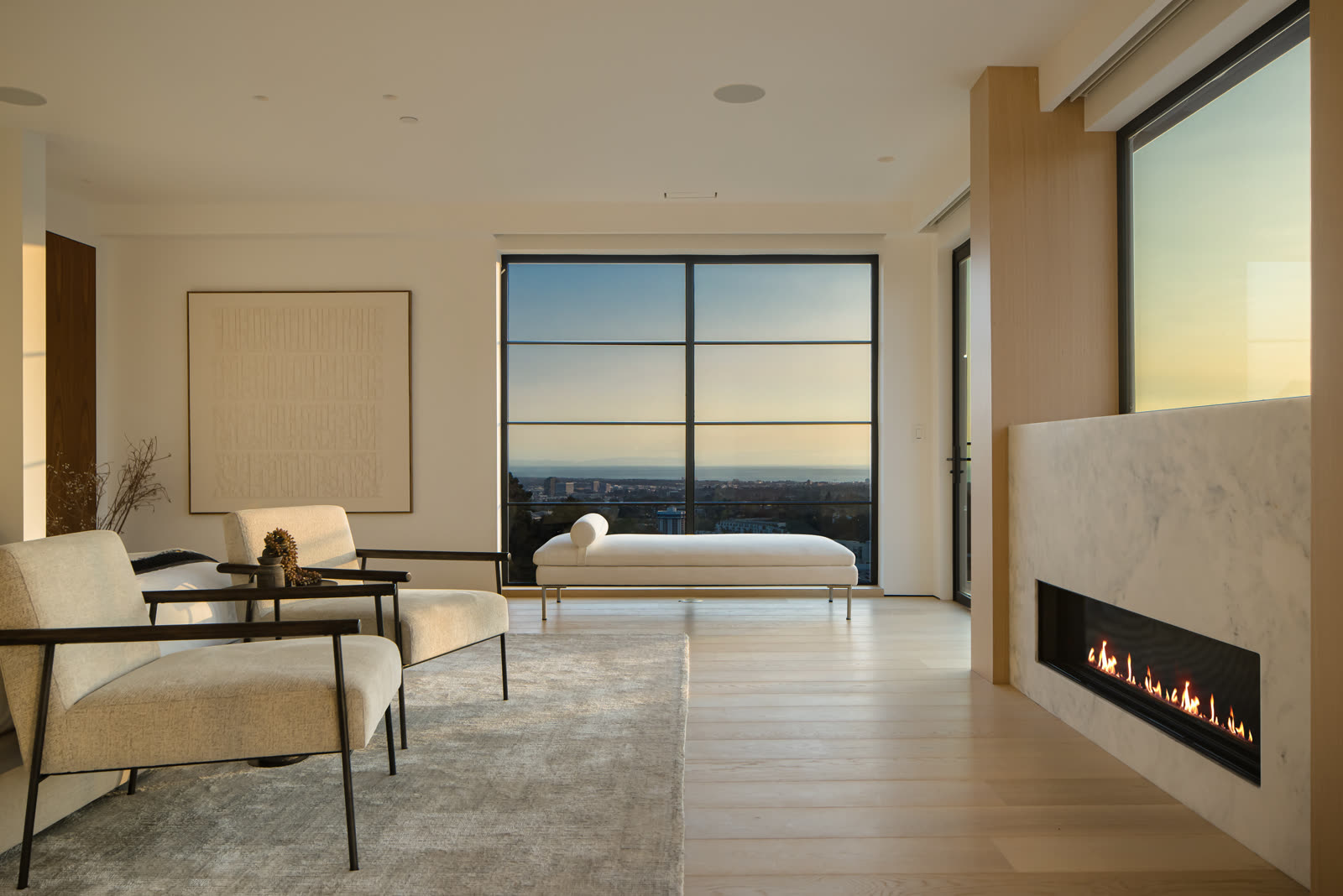 Primary bedroom with fireplace and ocean view