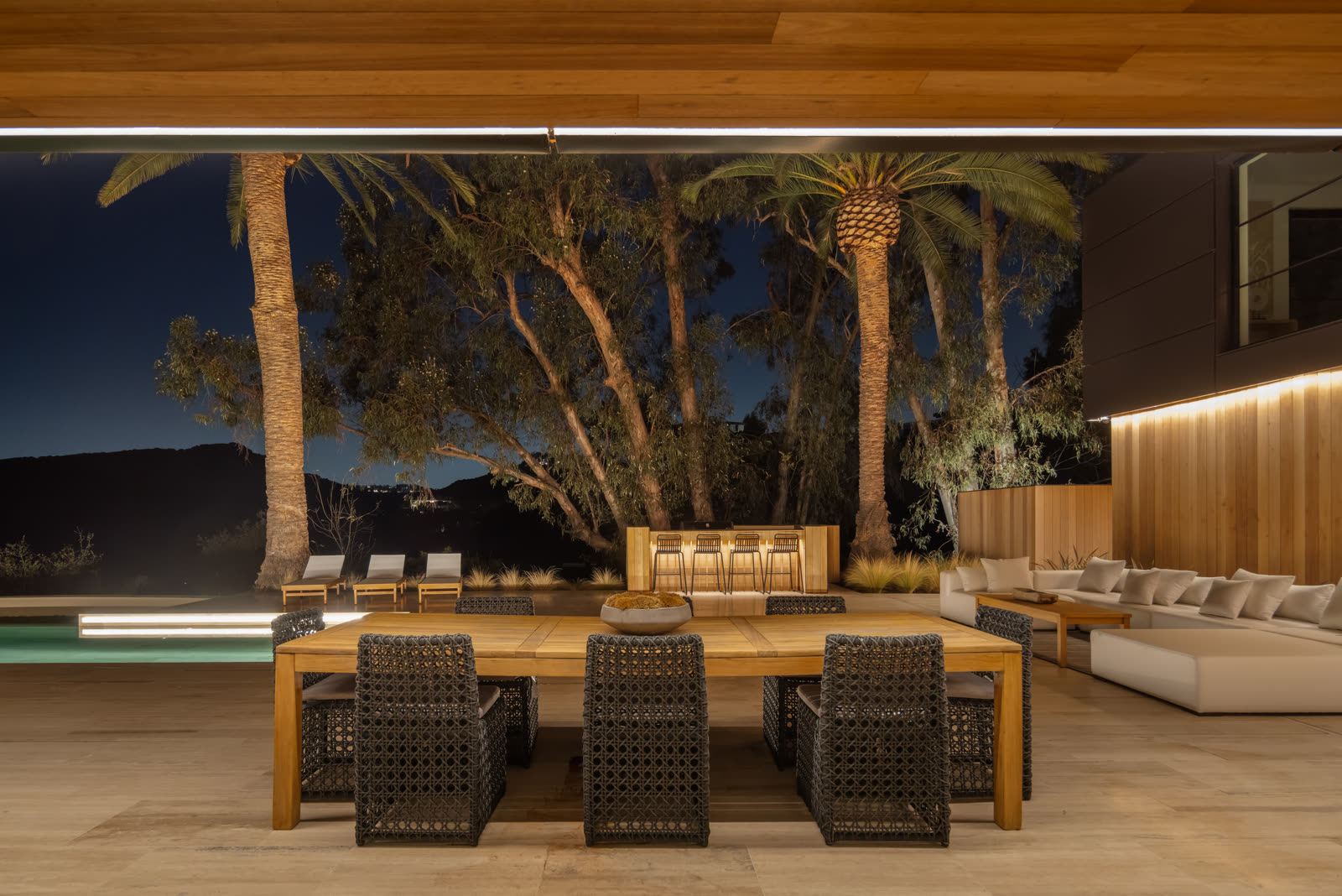 Outdoor dining at dusk under palms