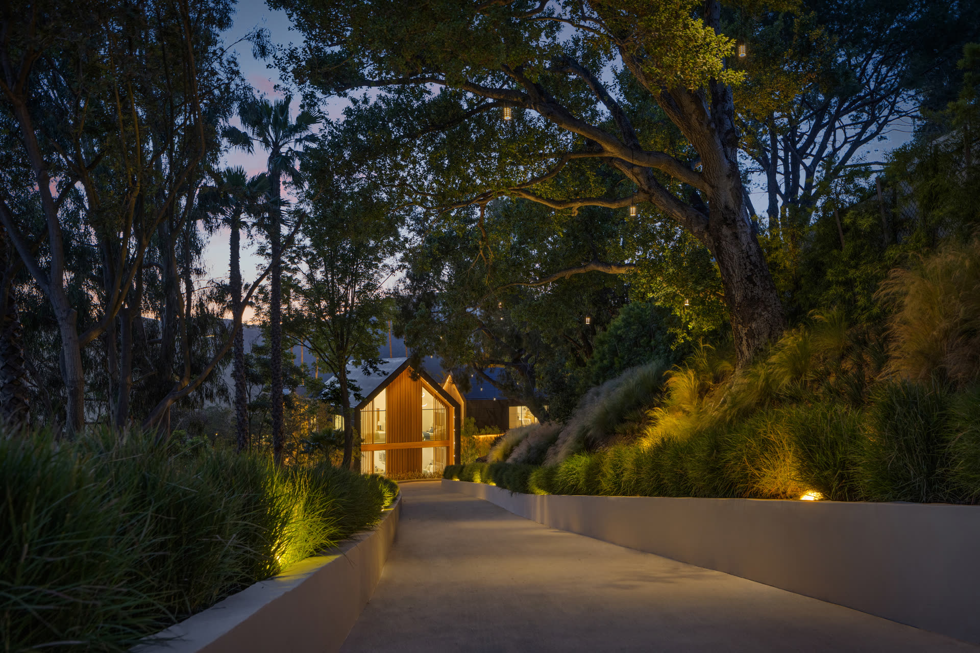 Lit path to the residence at dusk