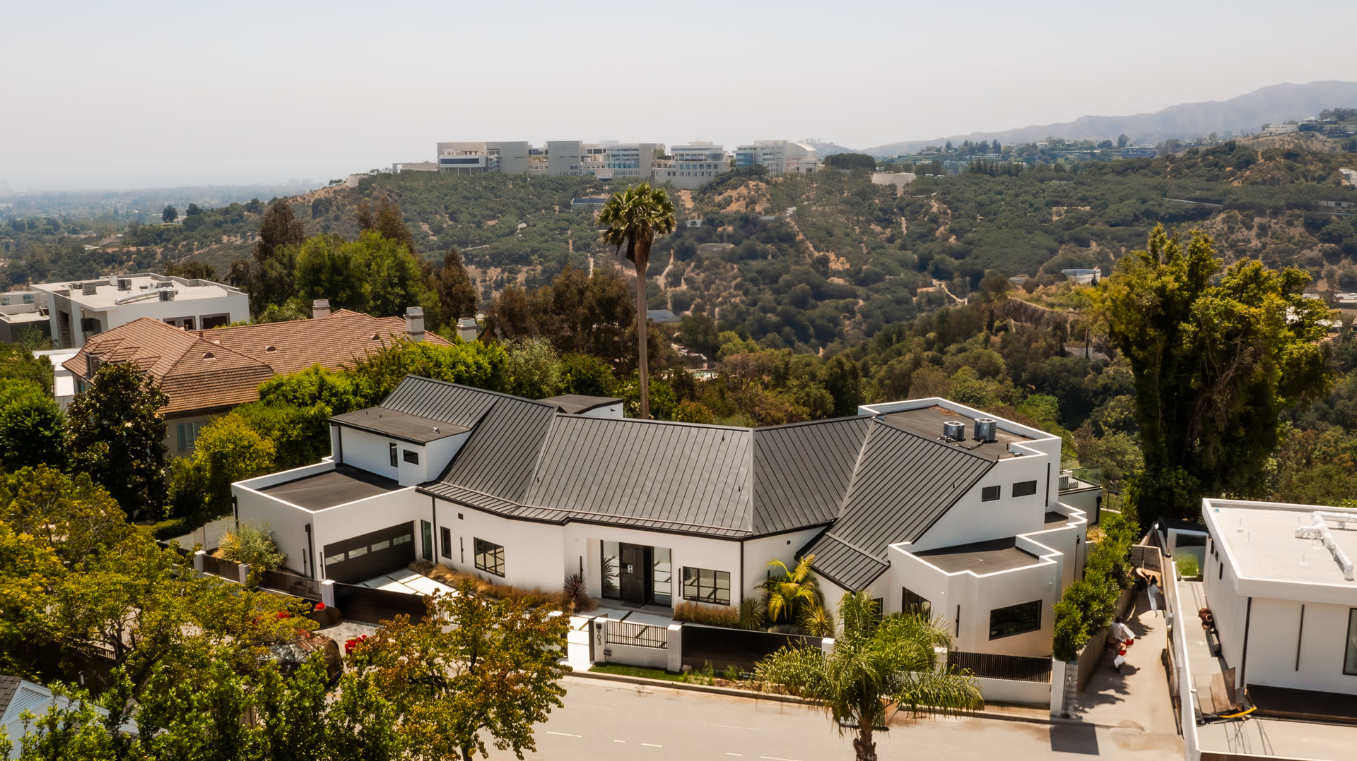 Aerial view of 903 Linda Flora, a white contemporary estate with pool